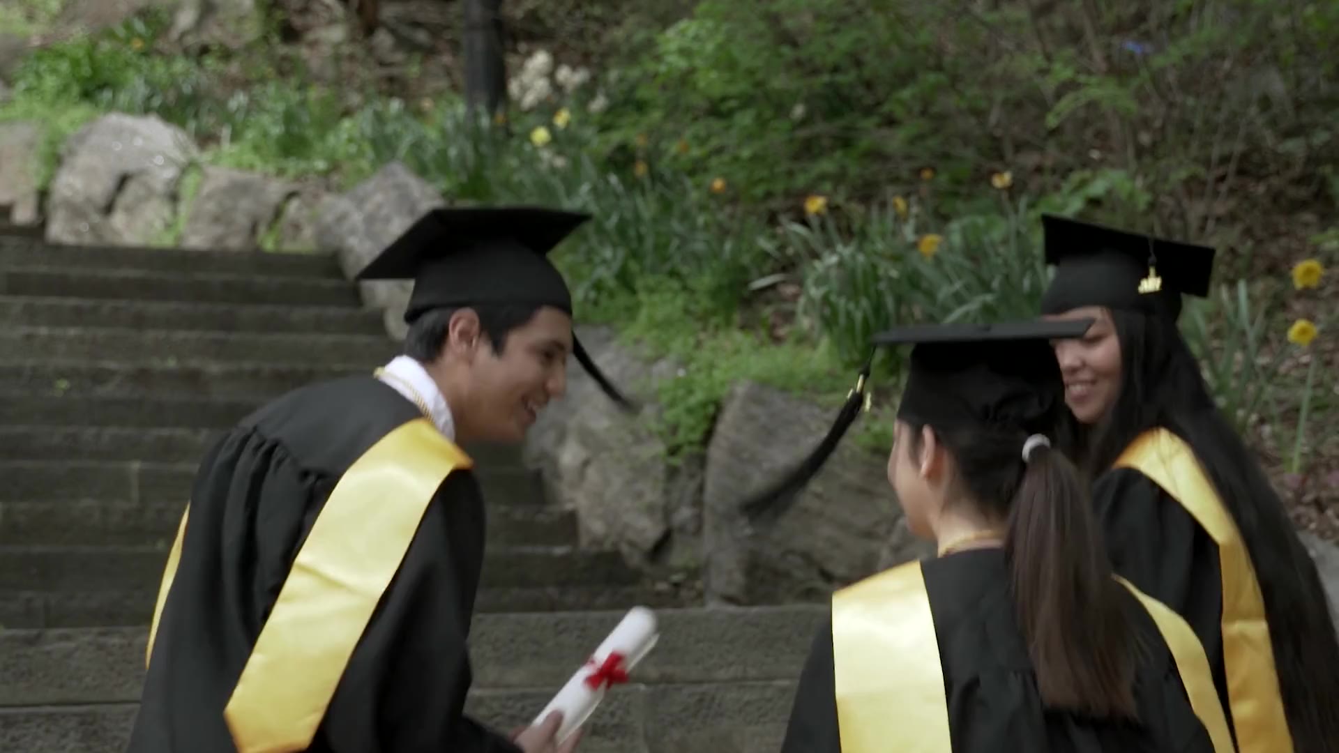 Students walking through a stone university courtyard in the morning.